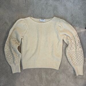 Woman’s white old navy sweater.